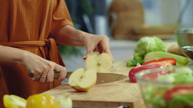 女人手切割红色的苹果厨房家庭主妇烹饪蔬菜沙拉